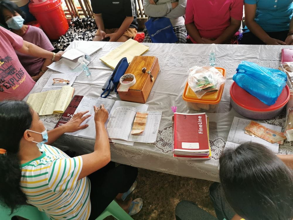 A self-help group sits on a table (Source: Kindernothilfe-Partner)